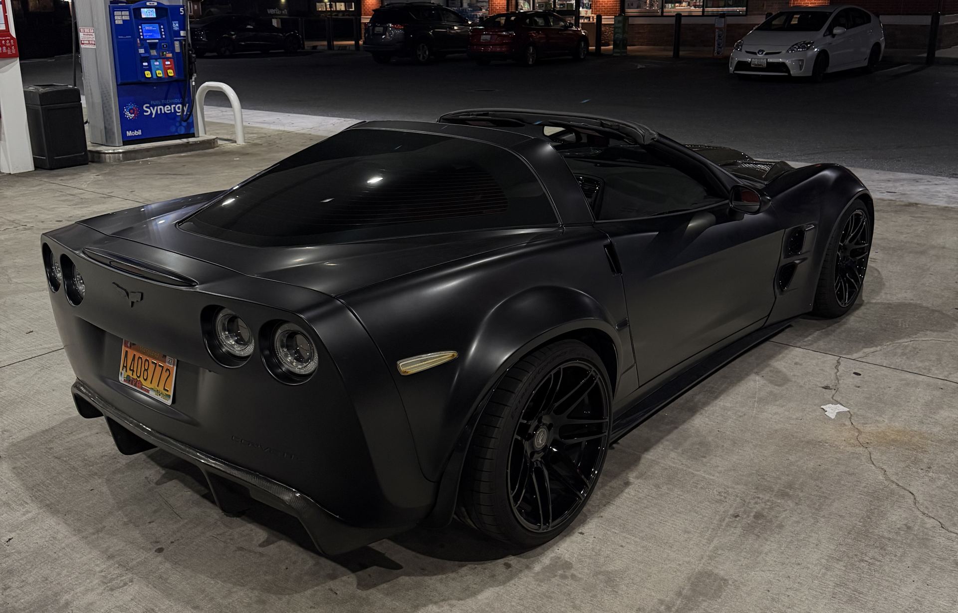 Widebody C6 Corvette from behind at night, tail lights lit